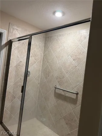 a bathroom with a glass shower door
