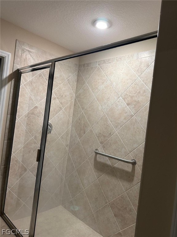 3740 Pebblebrook Ridge Court, Unit 102 Fort Myers, FL 33905 - Photo 25 of 46 a bathroom with a glass shower door