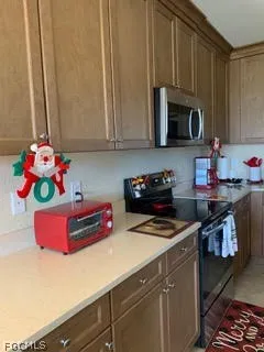 a kitchen with stainless steel appliances a microwave a stove and cabinets