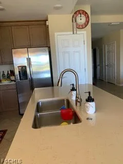 a kitchen with a refrigerator and a sink