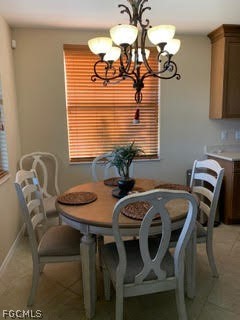 3740 Pebblebrook Ridge Court, Unit 102 Fort Myers, FL 33905 - Photo 9 of 46 a view of a dining room with furniture and chandelier
