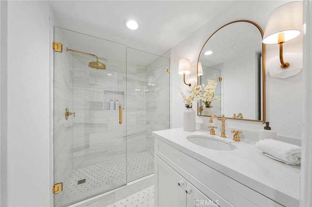 30050 Cielo Mesa Temecula, CA 92592 - Photo 19 of 43 a bathroom with a granite countertop sink a shower and a mirror
