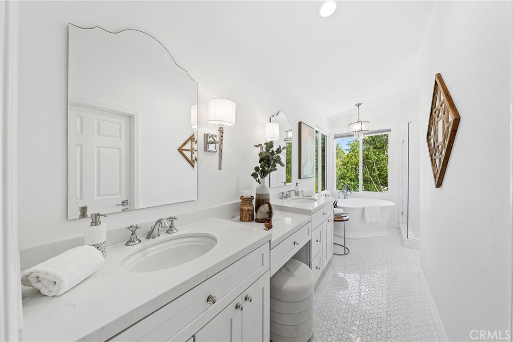 30050 Cielo Mesa Temecula, CA 92592 - Photo 29 of 43 a en suite bathroom with a double vanity sink and a mirror