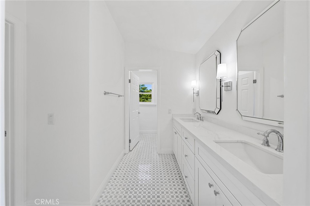 30050 Cielo Mesa Temecula, CA 92592 - Photo 33 of 43 a spacious bathroom with a double vanity sink and a mirror