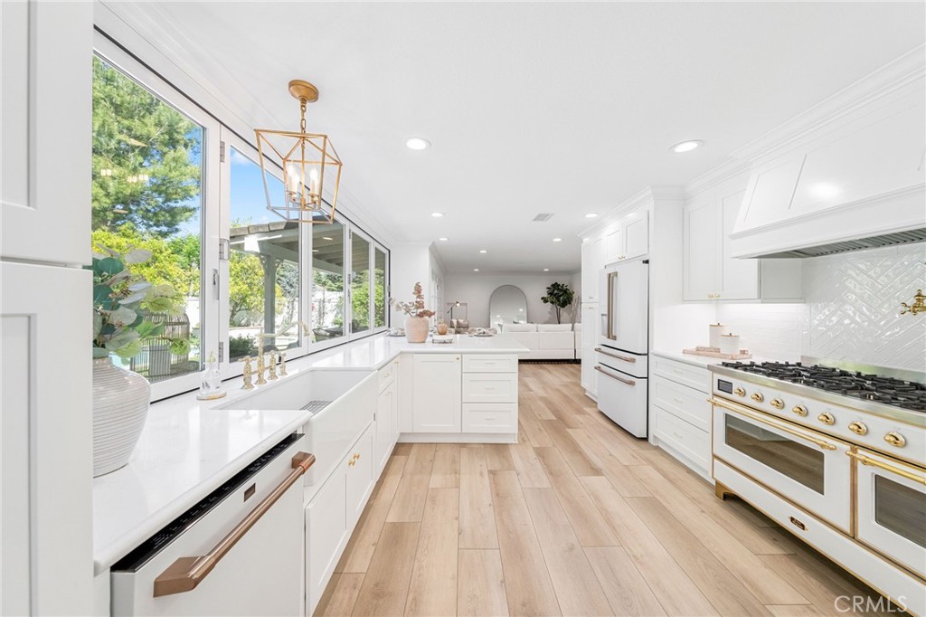 30050 Cielo Mesa Temecula, CA 92592 - Photo 8 of 43 a large white kitchen with stainless steel appliances granite countertop a lot of counter space and a wooden floors