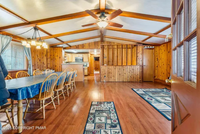 a kitchen with a refrigerator and wooden cabinets