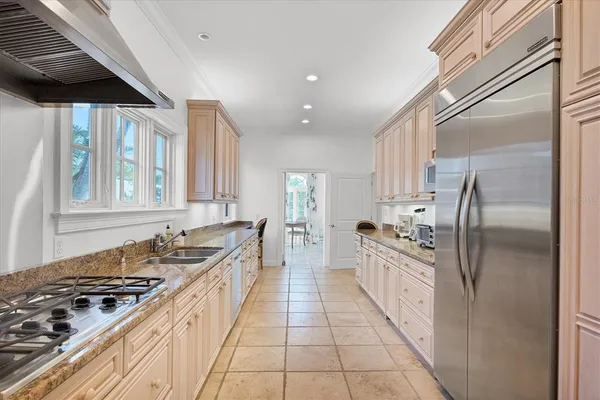 a dining room with furniture a chandelier and window