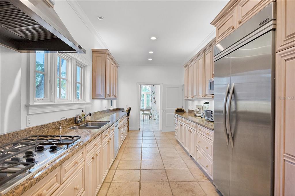 1031 10th Street West Boca Grande, FL 33921 - Photo 18 of 45 a large kitchen with stainless steel appliances granite countertop a stove and a sink