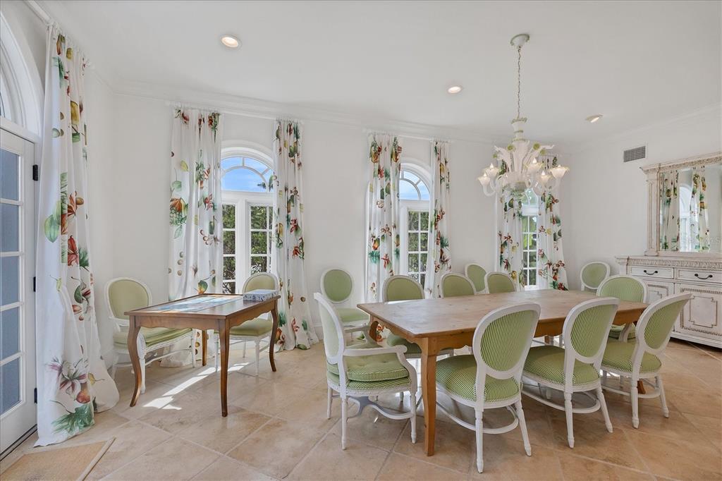 1031 10th Street West Boca Grande, FL 33921 - Photo 20 of 45 a dining room with furniture a chandelier and window