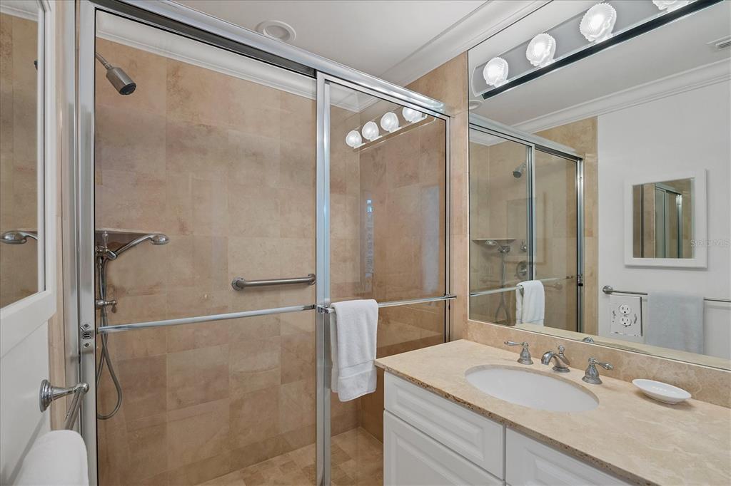 1031 10th Street West Boca Grande, FL 33921 - Photo 26 of 45 a bathroom with a granite countertop shower sink and mirror
