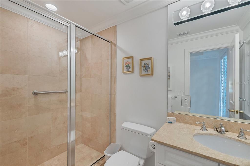 1031 10th Street West Boca Grande, FL 33921 - Photo 30 of 45 a bathroom with a granite countertop sink toilet and shower