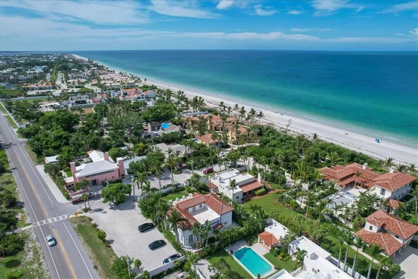 an aerial view of residential houses with outdoor space and street view