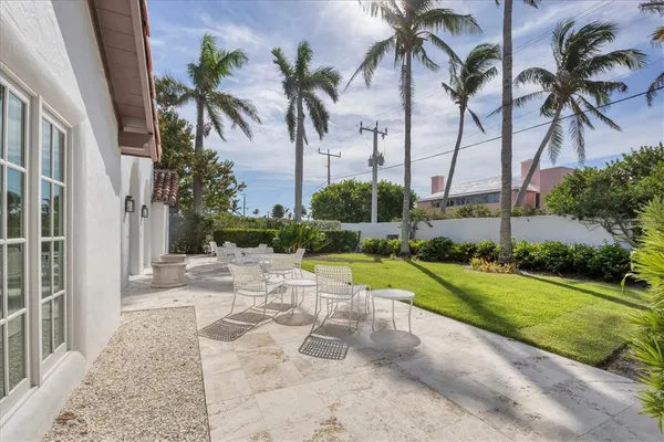 a view of a patio with table and chairs and potted plants