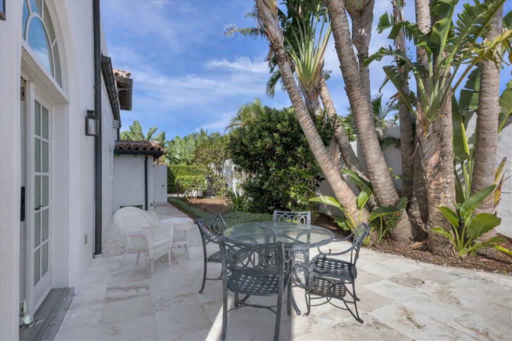 1031 10th Street West Boca Grande, FL 33921 - Photo 40 of 45 a view of a patio with table and chairs and potted plants
