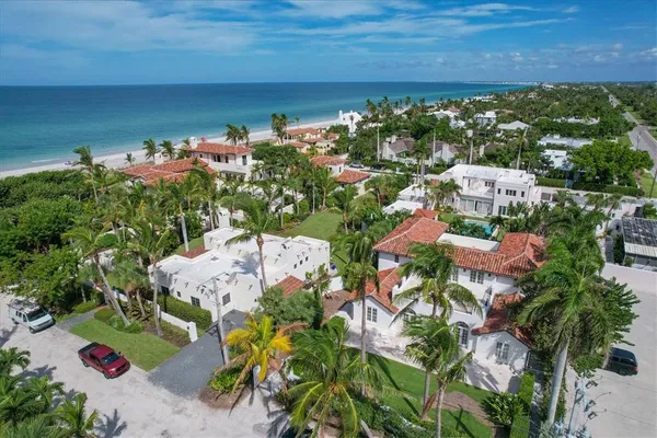 an aerial view of a house with garden space and lake view