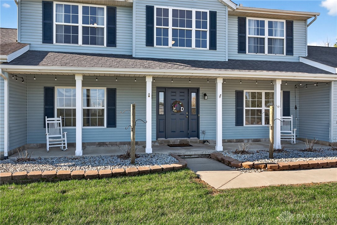 6560 Snyder Road Fletcher, OH 45326 - Photo 4 of 71 This inviting home features a charming front porch, ideal for enjoying peaceful moments outdoors.