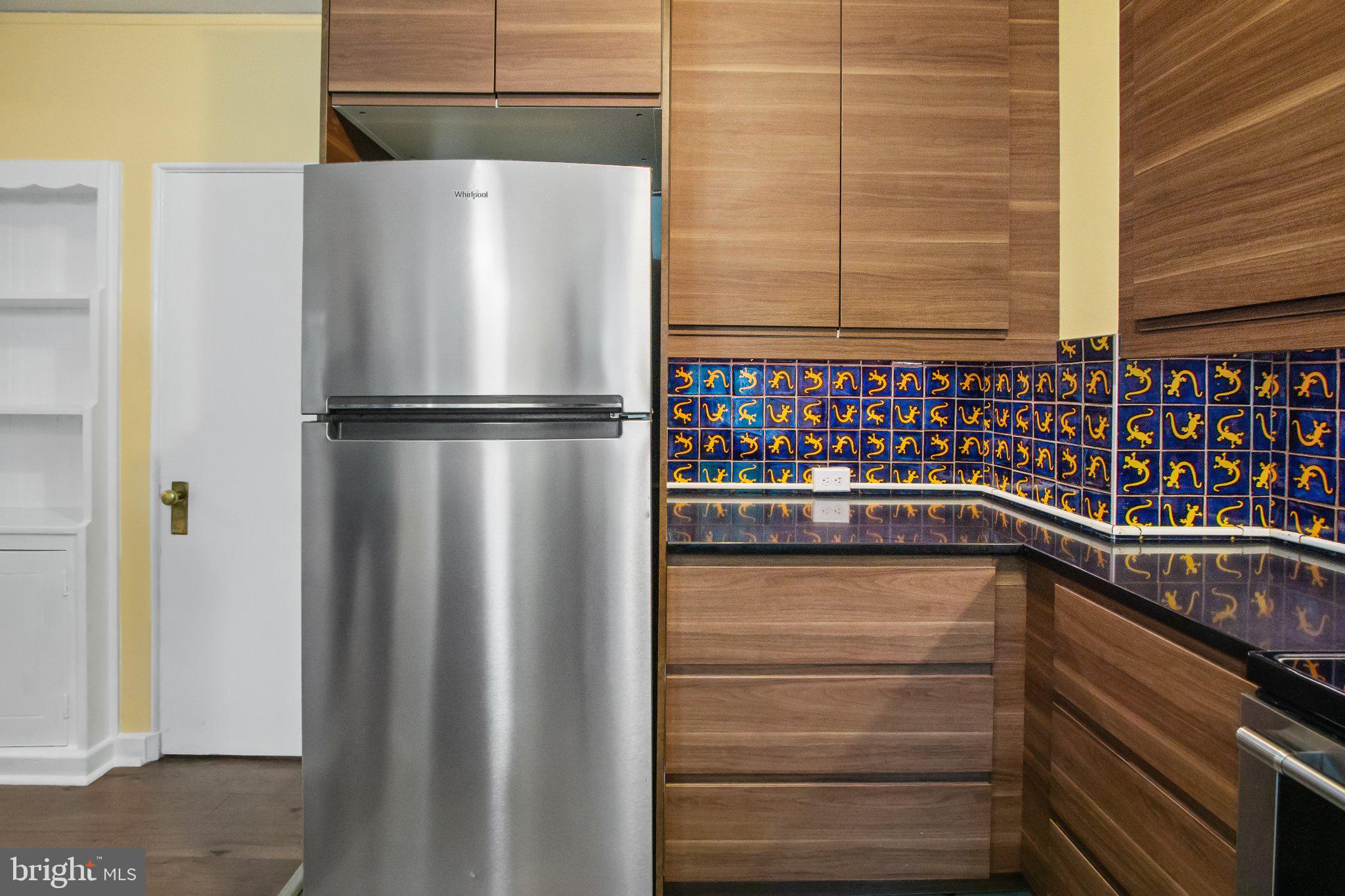 30 Ridge Road, Unit B Greenbelt, MD 20770 - Photo 14 of 30 Sleek kitchen with vibrant tile accents.