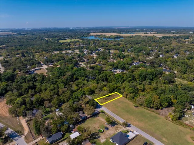 an aerial view of a residential houses with city view