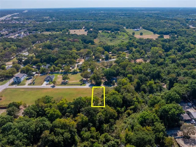 an aerial view of a houses with a yard