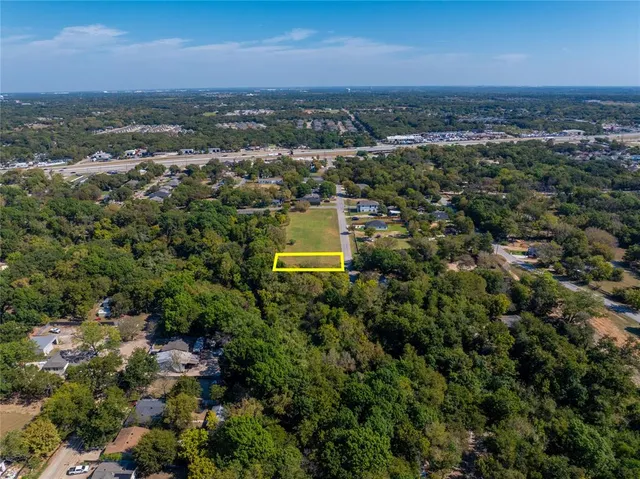 an aerial view of residential building with green space