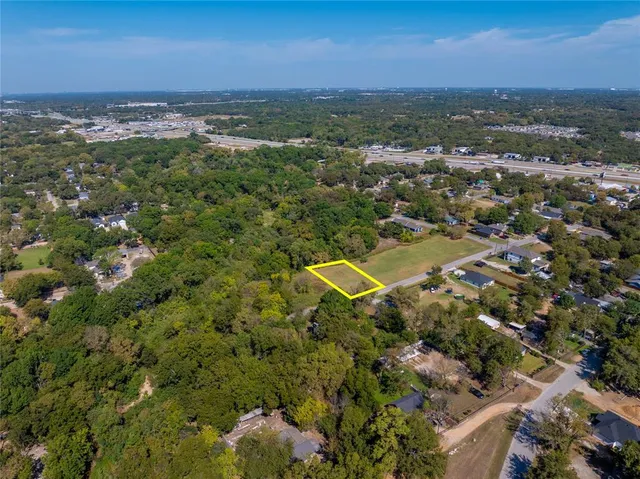 an aerial view of a houses with a yard