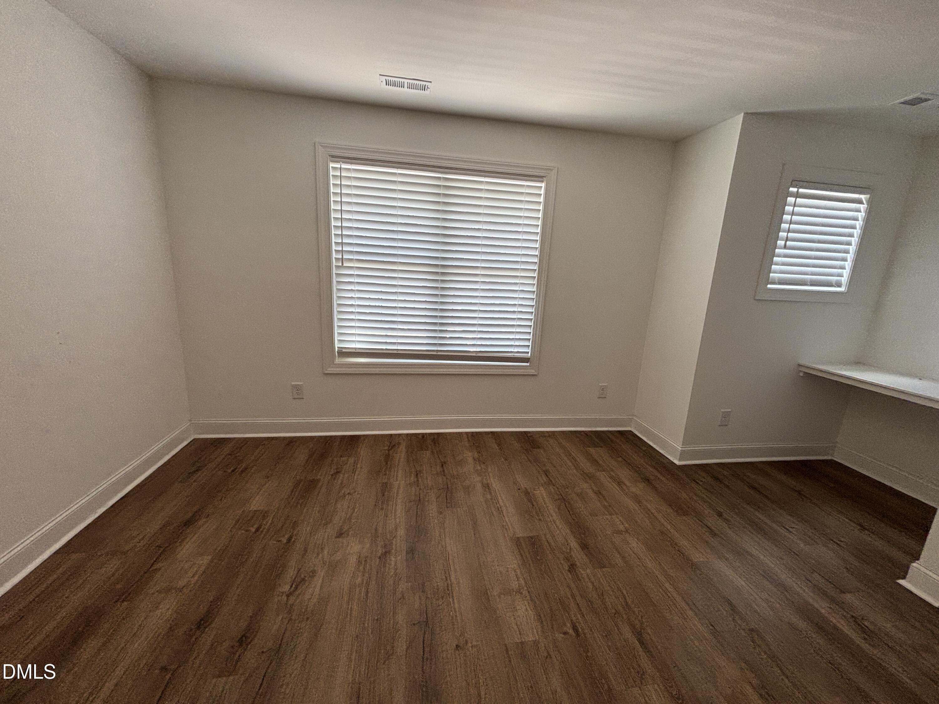 5710 Parker Pnes Court Raleigh, NC 27609 - Photo 60 of 78 an empty room with wooden floor and windows