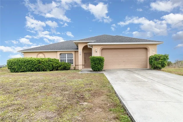 a front view of a house with a yard and garage