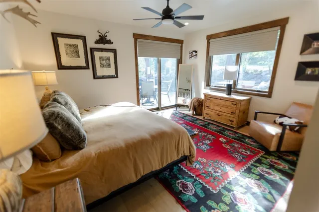 a bed sitting in a bedroom next to a window