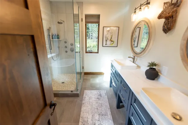 a bathroom with a sink a toilet and a mirror