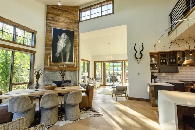 a living room with fireplace furniture and a large window