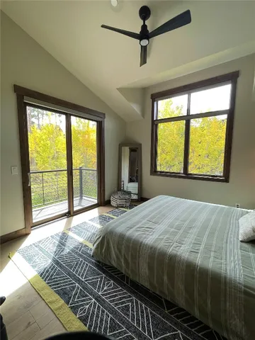 a bedroom with a large bed and a large window