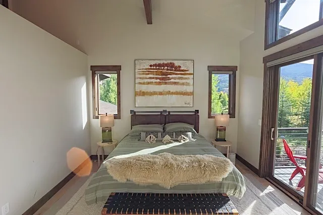 a bed sitting in a bedroom next to a window