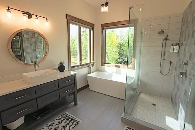 a bathroom with a sink mirror bathtub and shower