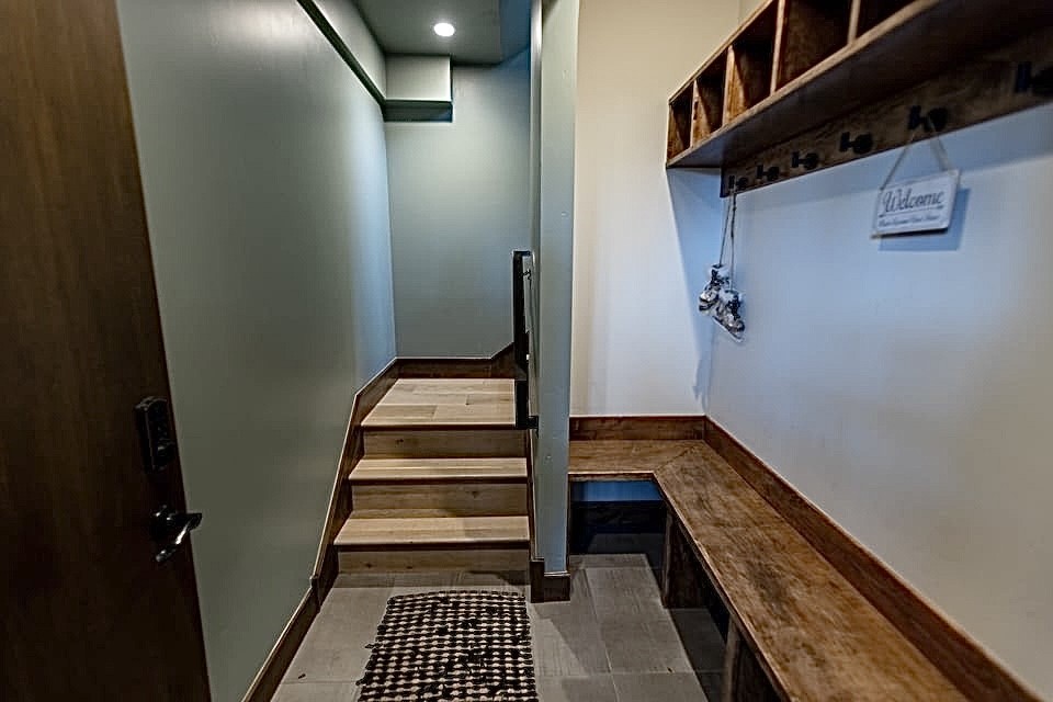 230 Game Trail Road Silverthorne, CO 80498 - Photo 39 of 46 a view of a hallway with wooden floor and staircase