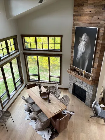 a view of a livingroom with workspace and a fireplace