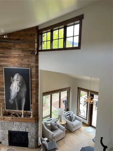 a living room with furniture a fireplace and a flat screen tv