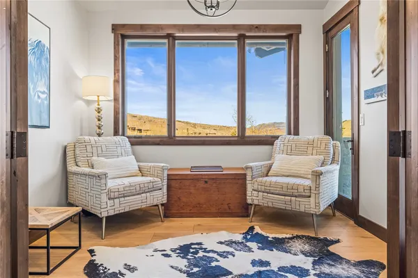 a living room with furniture and large windows