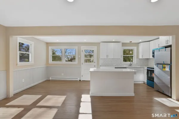 a kitchen with cabinets and wooden floor
