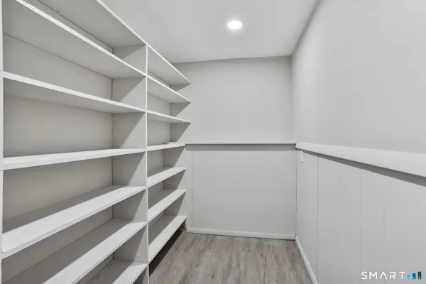 a view of walk in closet with empty racks