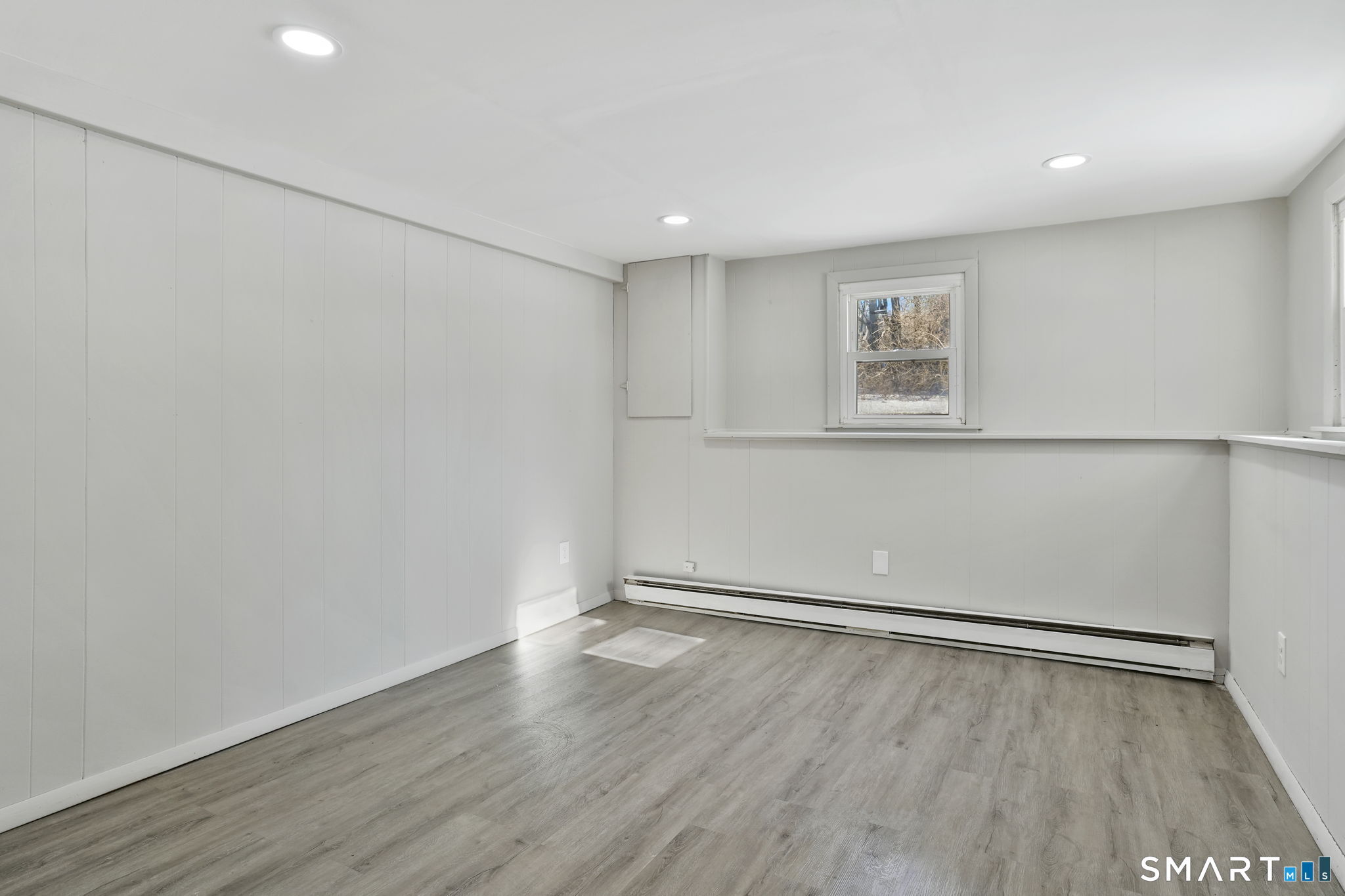 1 Winfield Avenue Wolcott, CT 06716 - Photo 27 of 37 an empty room with wooden floor and windows