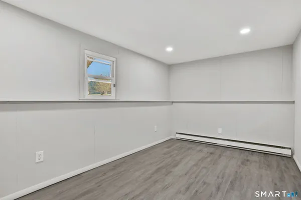 a view of a room with wooden floor