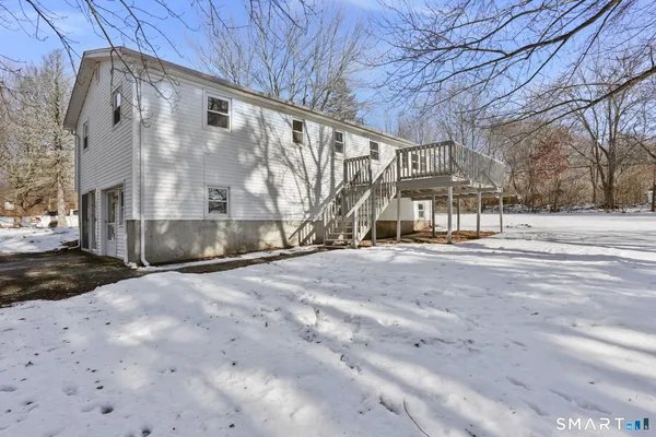 a view of a house with snow on the road