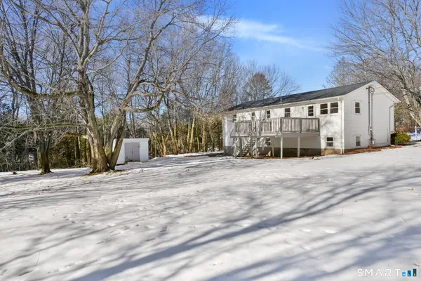 a view of a house with snow on the road