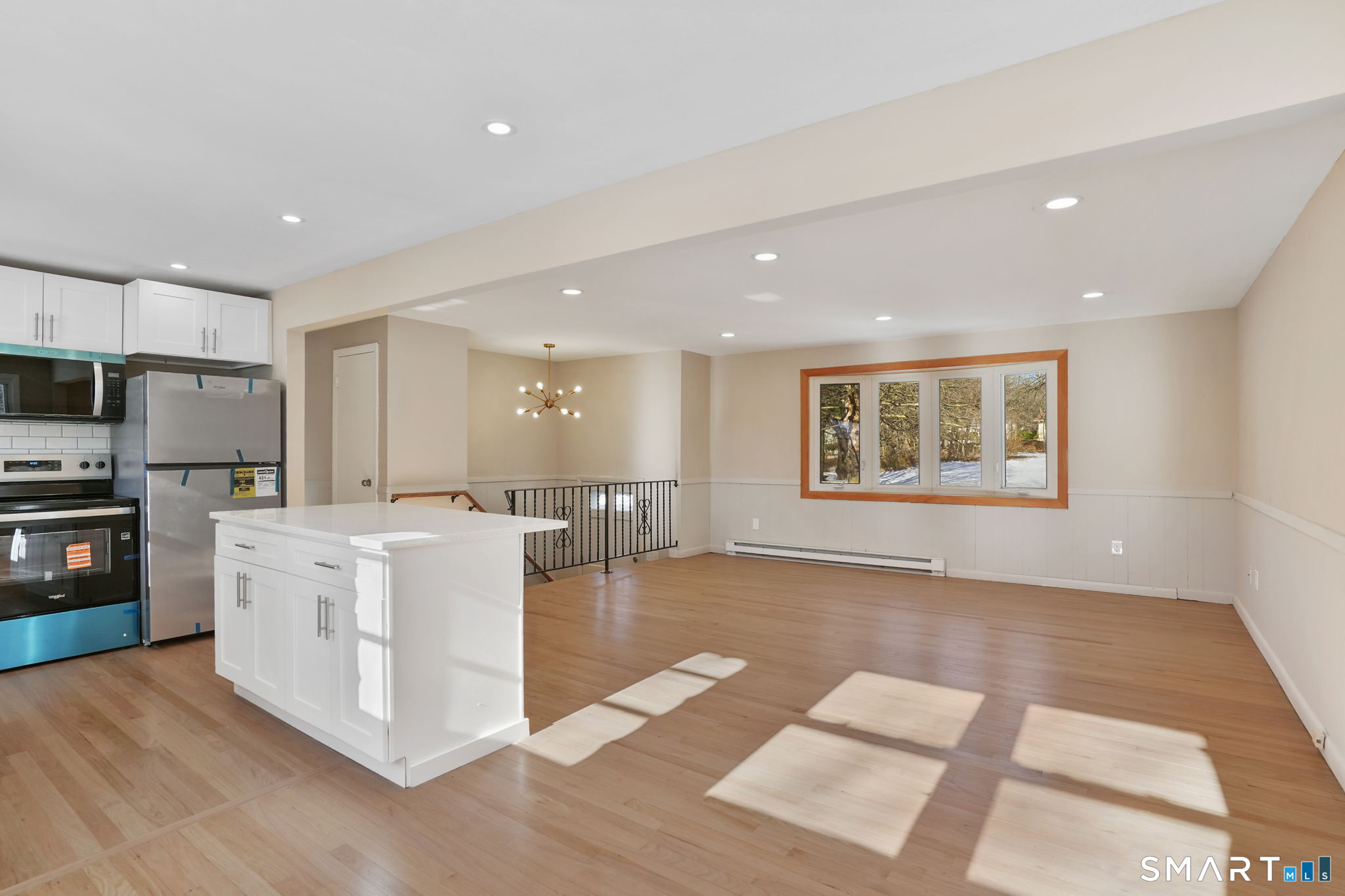 1 Winfield Avenue Wolcott, CT 06716 - Photo 10 of 37 a kitchen with stainless steel appliances granite countertop a refrigerator a stove top oven a sink dishwasher and white cabinets with wooden floor