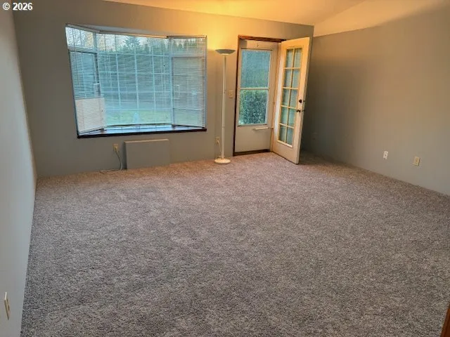 a dining room with furniture and a mirror