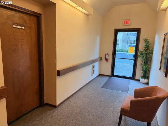 a hallway with furniture and a window