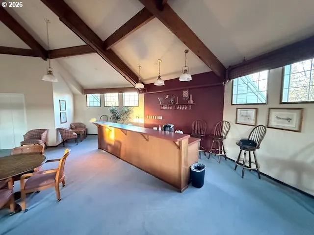a living room with furniture and a dining table