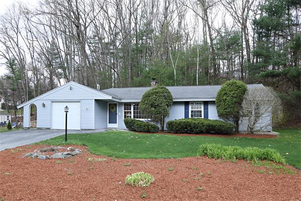 6 Marina Road Chelmsford, MA 01824 - Photo 1 of 7 a front view of a house with a garden and trees