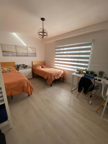 a view of a livingroom with furniture and a window