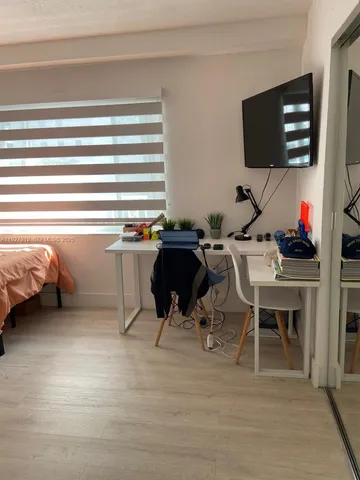 a workspace with furniture and a flat screen tv